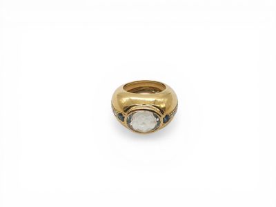 a close up of a gold ring with a white diamond