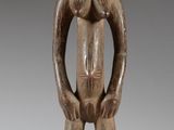 an image of a wooden statue of a man with a hat on his head