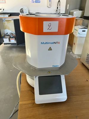 an orange and white machine sitting on top of a wooden table