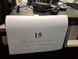 a sign on a desk that reads 15