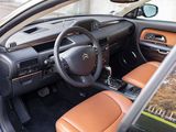 the interior of a car with leather seats and a steering wheel