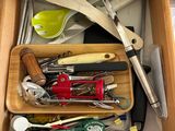 a drawer full of kitchen utensils and other kitchen tools