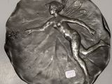 silver plate with a fairy sitting on top of it on a table