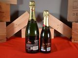 two bottles of wine sitting next to each other on a table