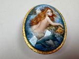 a picture of a mermaid sitting on a rock in the water