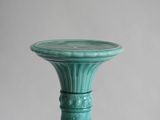 a green vase that is sitting on a table