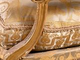 a gold couch with a gold and white pattern on it