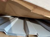 a person that is opening a box with a sheet of paper