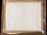 an old picture frame sitting on top of a wooden easel in a room
