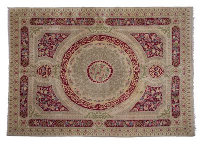 a red and beige rug with a medallion design on it