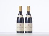 two bottles of wine sitting on top of a table