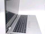 a silver laptop computer sitting on a white surface