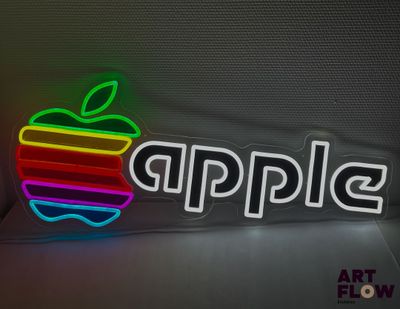 une enseigne lumineuse en forme de pomme posée sur une table