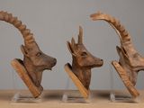 three sculptures of animals that are on display on a table