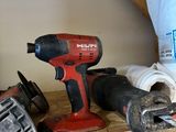 some tools are sitting on top of a wooden shelf in a room