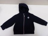 a small child ' s jacket with a hoodie on it