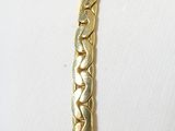 an image of a close up of a gold bracelet on a mannequin