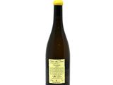 a bottle of wine sitting on top of a white table