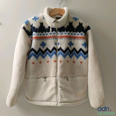 an image of a white jacket with a blue and orange pattern on it