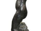 statue of a man standing on a rock with his head in his hands