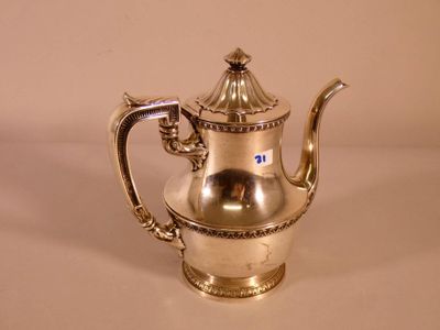 a silver tea pot sitting on a white surface