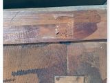 a picture of a piece of wood with a sign on it