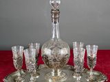 a silver tray with wine glasses and a decanter on it