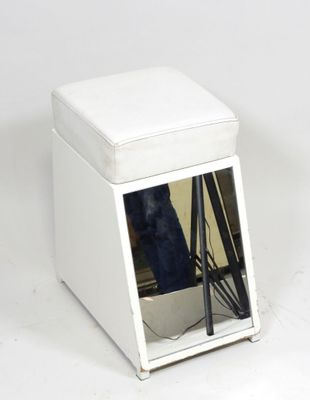 a small white ottoman with a television in it