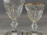 pair of cut glass goblets with gold rims