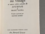 an open book with a picture of a village on it