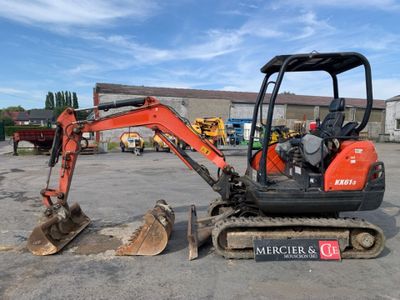 a small excavator that is parked in a parking lot