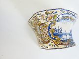 a blue and white vase with a picture of a ship on it