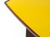 an image of a yellow surfboard sitting on top of a wooden table