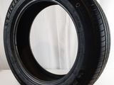 a close up of a tire on a white surface with a curtain in the background