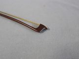 a close up of a small metal object on a white surface