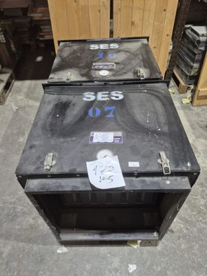 two black boxes sitting on the floor next to each other