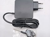 an image of a black charger and cord on a white surface