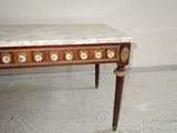 a marble top table with gold decorations on it