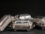 four pieces of silverware sitting on top of each other on a black surface