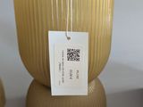 two vases with tags on them sitting on a table