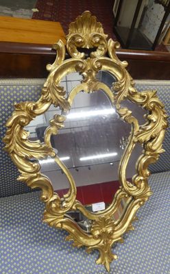 an ornate gold mirror sitting on top of a blue couch