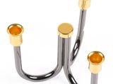 pair of black and gold metal candlesticks on a white background