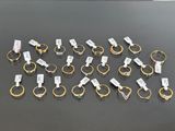 a bunch of gold and silver rings with tags on them