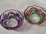 two colorful glass bowls sitting on a white surface