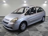 a picture of a small silver car parked in a garage