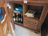 a wooden cabinet with a bunch of wine bottles on it