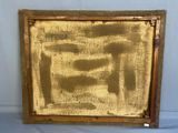 an old picture frame with gold paint on it sitting on a table