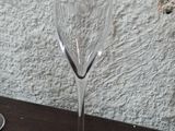 two wine glasses sitting on a table next to each other