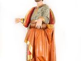 statue of a man with a beard and a robe on a wooden base
