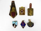 several badges are arranged on a white surface with a white background